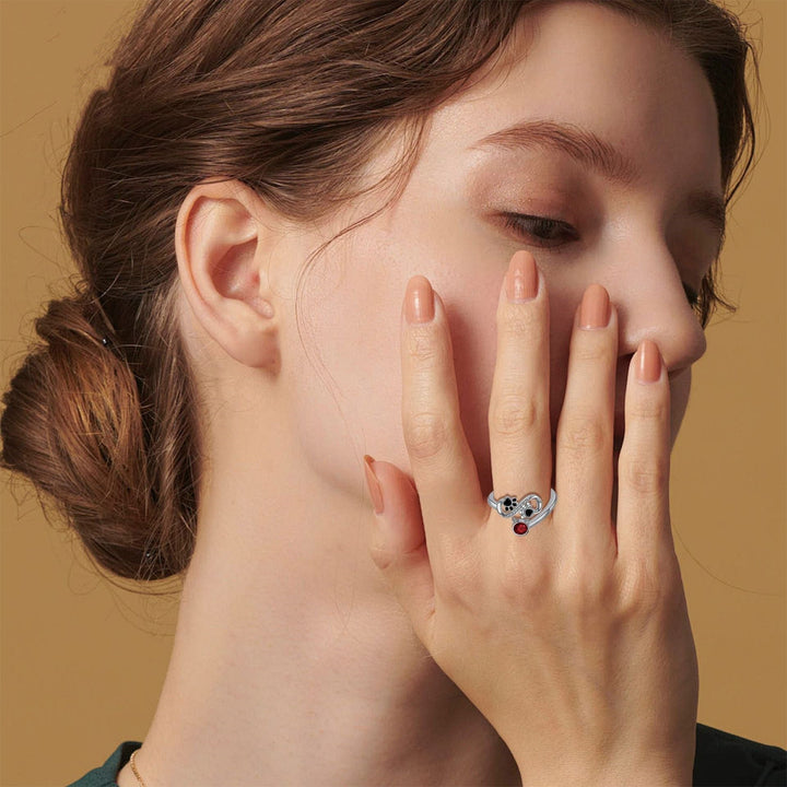 Adjustable ring with black paw print and red gemstone
